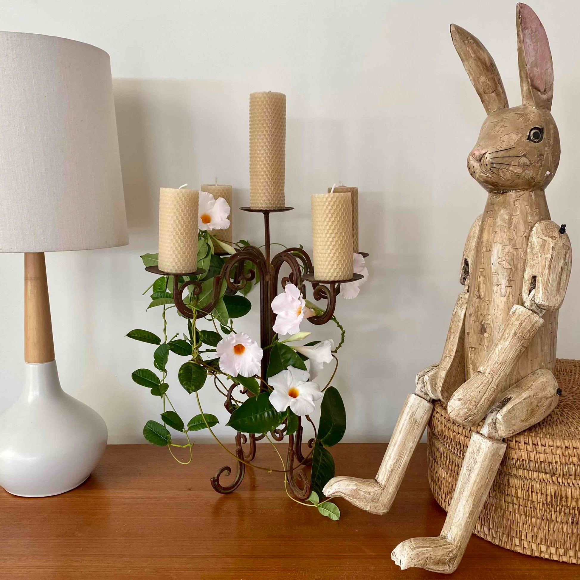 beeswax  candles in candlebra with lamp and wooden rabbit